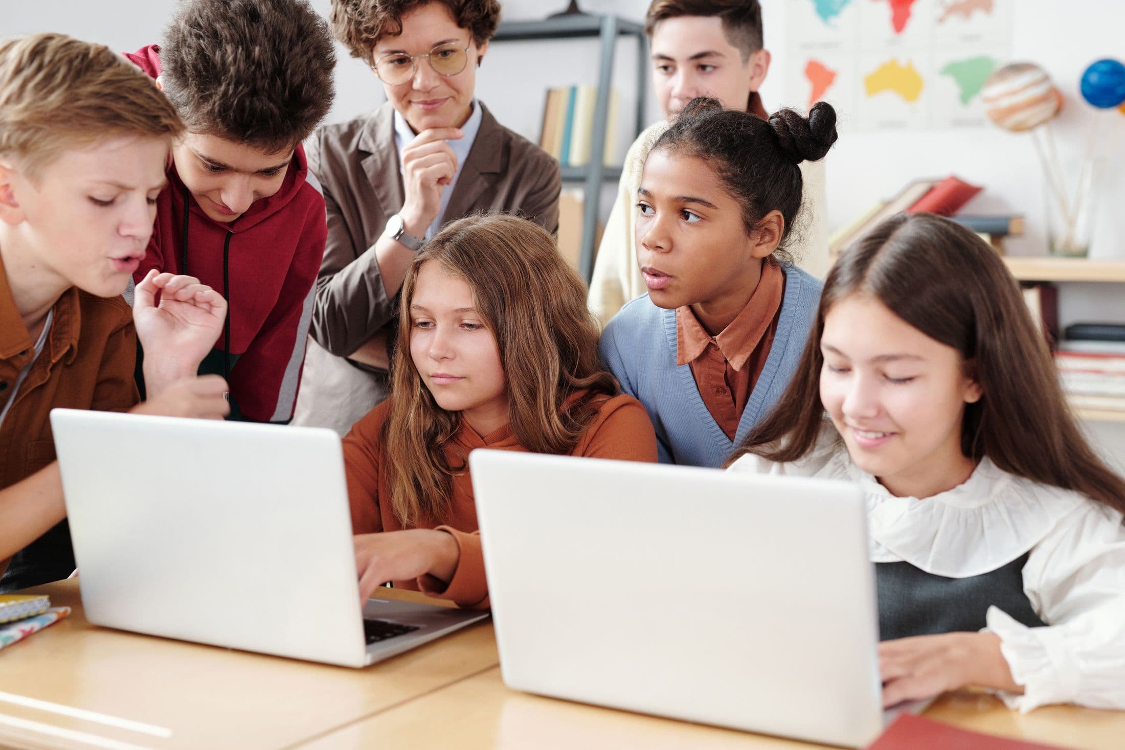 Students working together with laptops in a learning setting